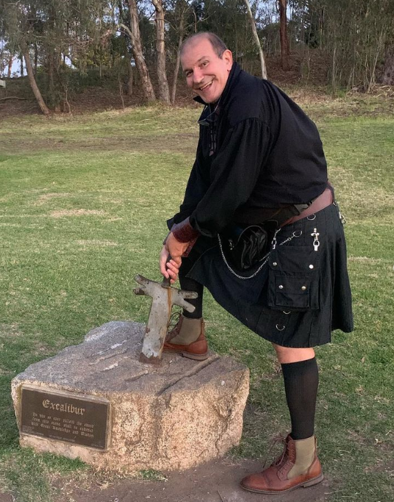 George Maccagnan of Highland Leather draws a sword from a stone